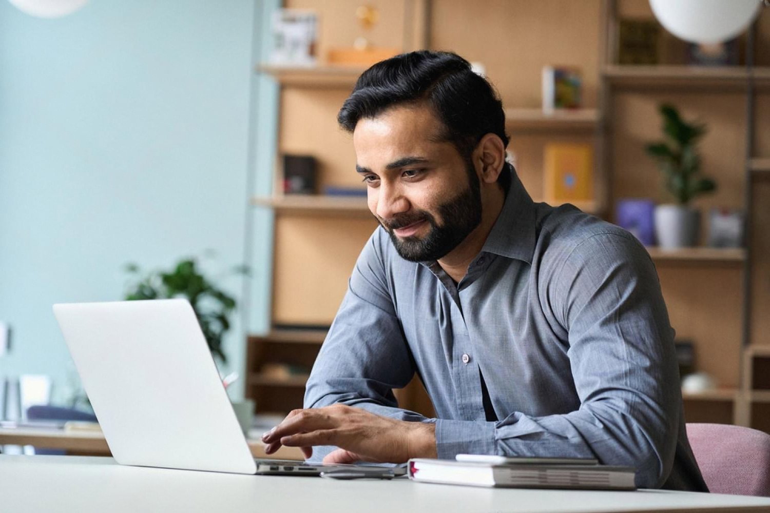Business founder registering a .ae domain on a laptop