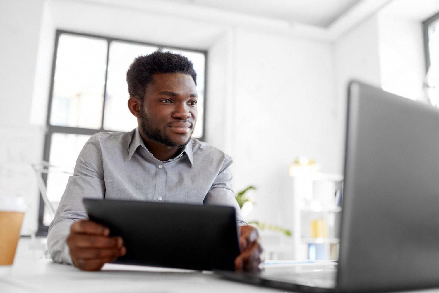 Entrepreneur reviewing domain name options on a tablet in a Dubai office