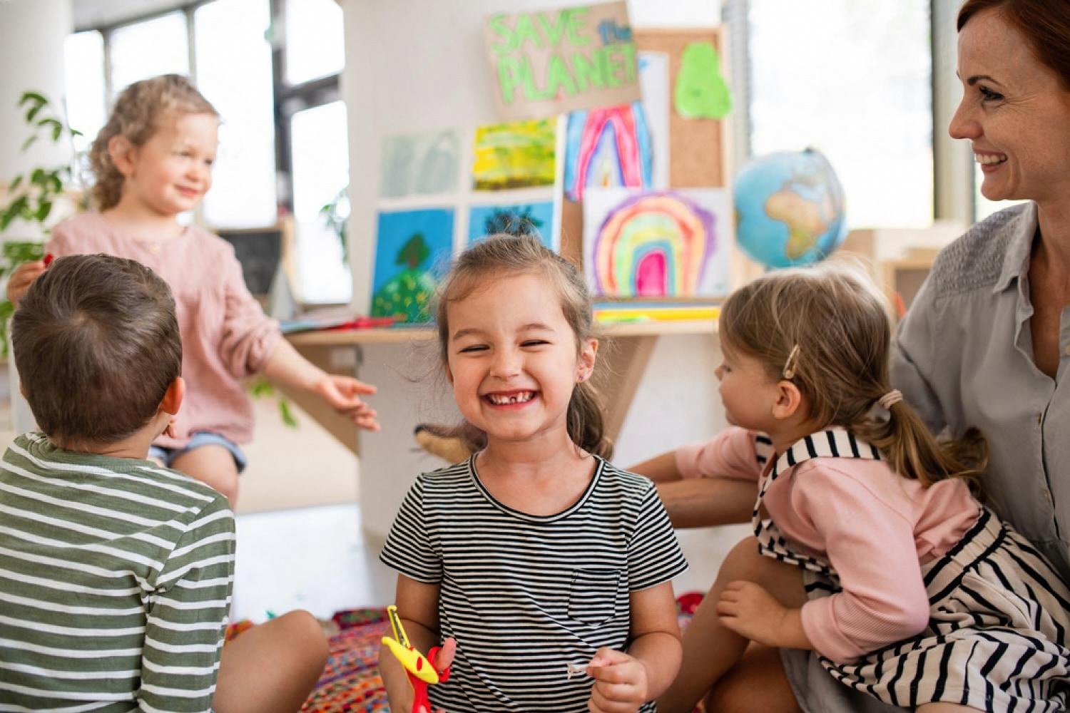 Primary school children with their teacher during a classroom activity